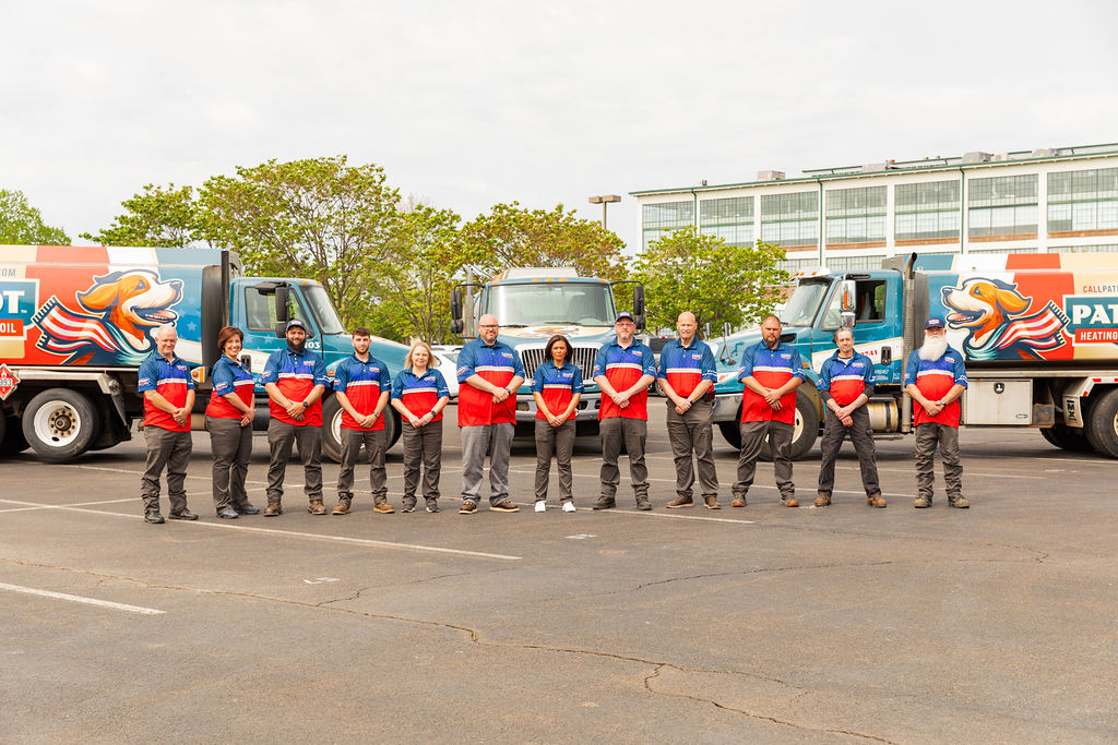 Fairless Hills HVAC services team from Patriot Heating, Air and Fuel Oil standing in front of branded trucks