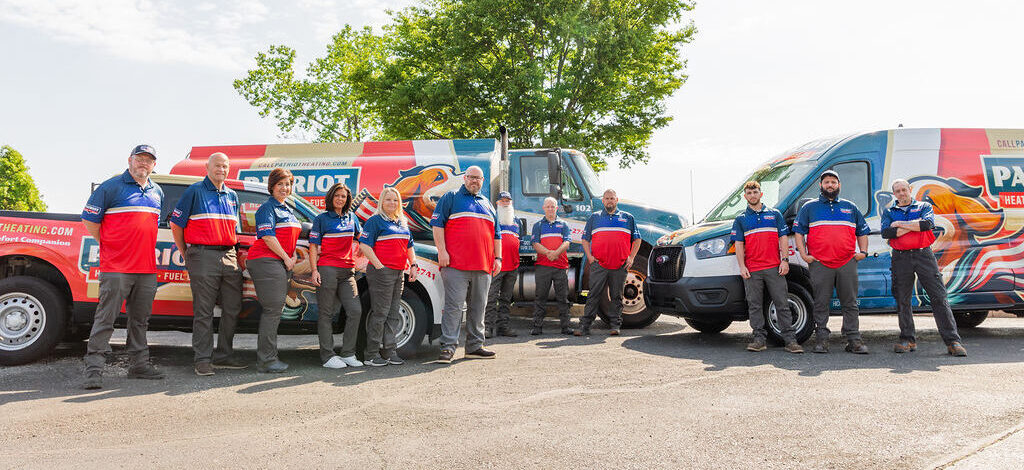 Heating services team in Morrisville, PA, posing in front of Patriot service vans