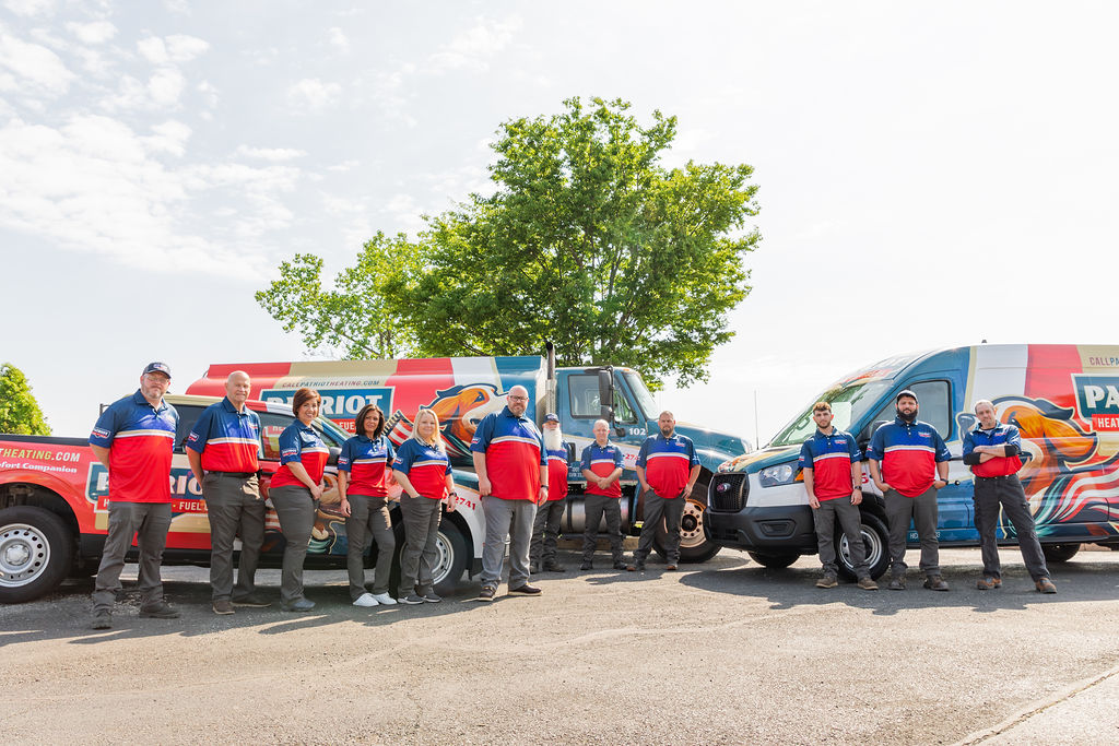 HVAC services team from Patriot Heating, Air and Fuel Oil in Morrisville, PA, posing in front of branded service vans