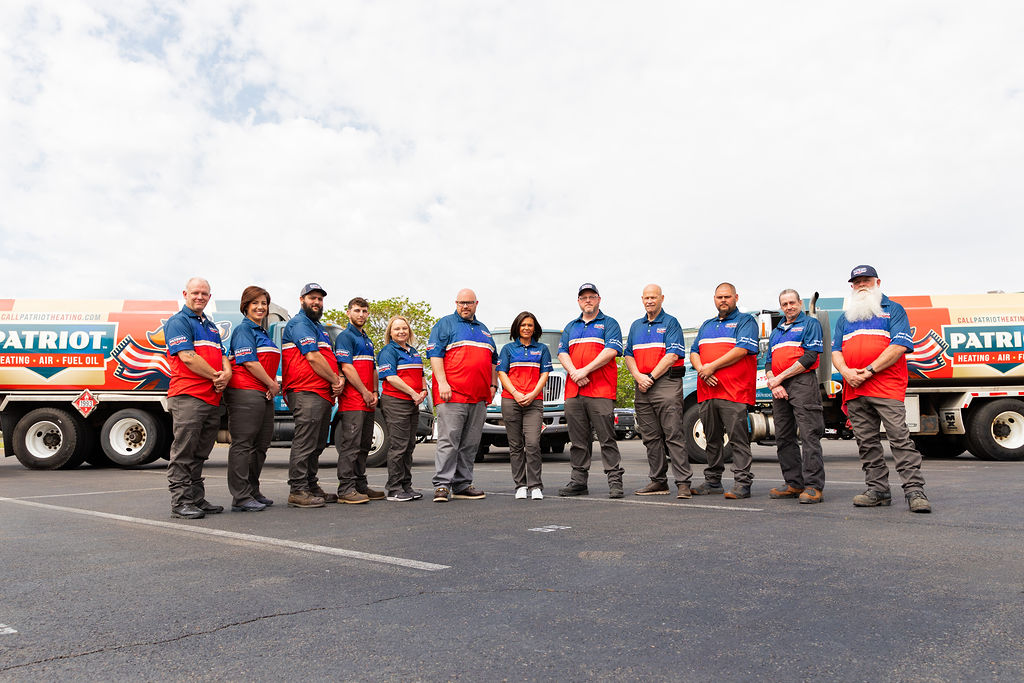 Patriot Heating, Air and Fuel Oil’s AC services team poses in front of branded vehicles, ready to provide AC services in Doylestown, PA