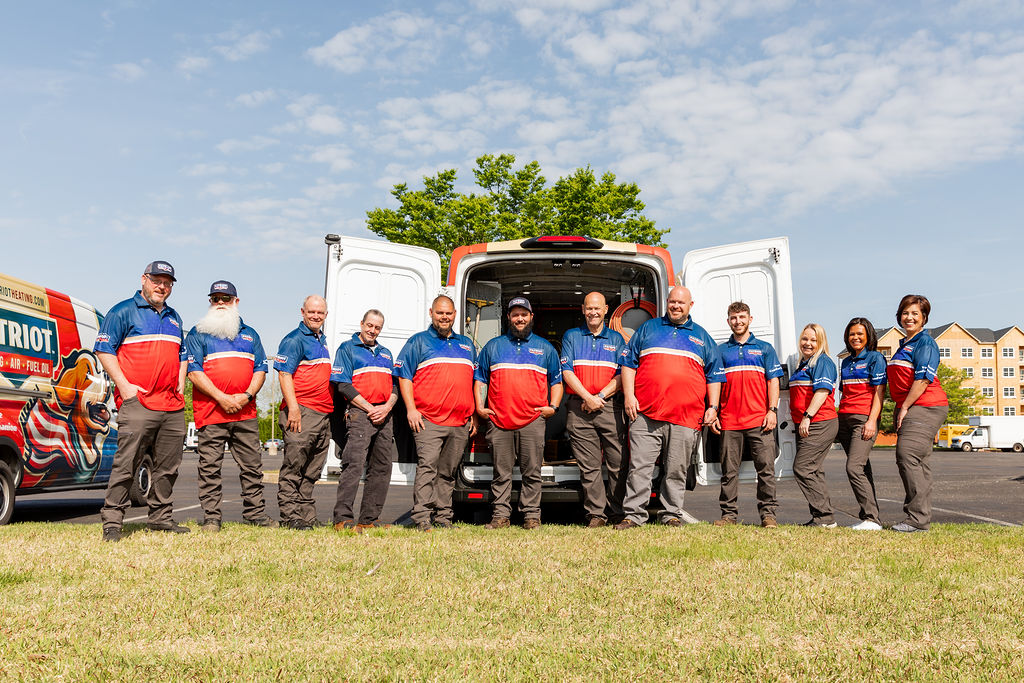 the Patriot Heating, Air, and Fuel Oil team stands in front of two branded vehicles, ready to deliver expert HVAC services to Bucks and Montgomery County residents
